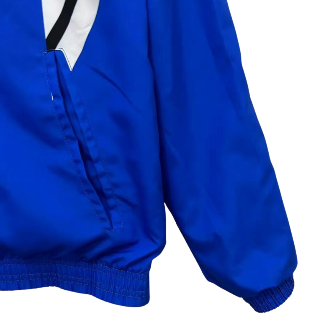 BAJO ENCARGO CHAQUETA MANCHESTER UNITED ROMPEVIENTOS REVERSIBLE