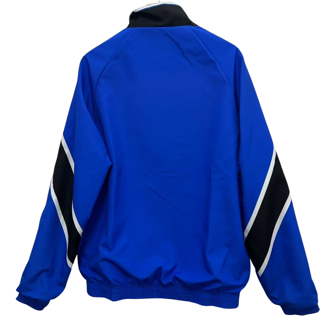 BAJO ENCARGO CHAQUETA MANCHESTER UNITED ROMPEVIENTOS REVERSIBLE